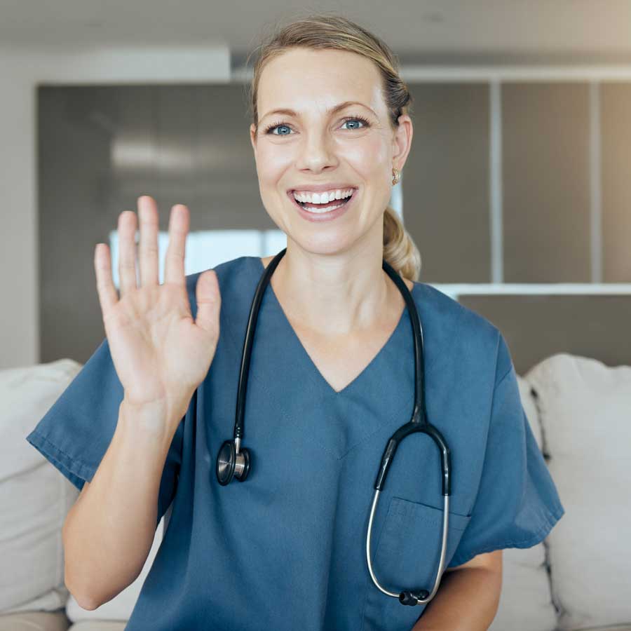Smiling nurse waving her hand after taking a job placement through Legacy Visiting Health.
